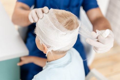 child receiving medical treatment after head injury